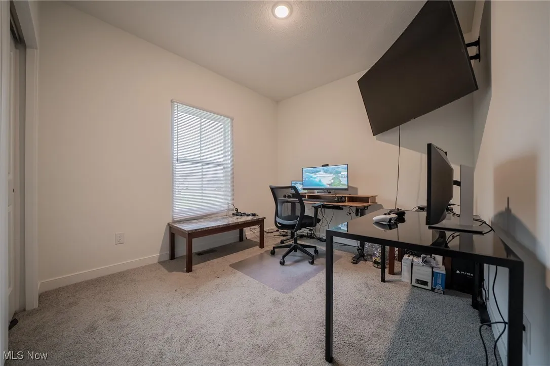 Carpeted office featuring baseboards