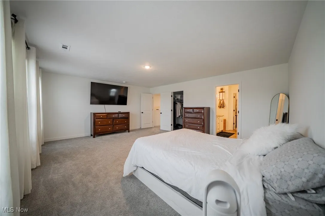 Bedroom featuring carpet floors and baseboards