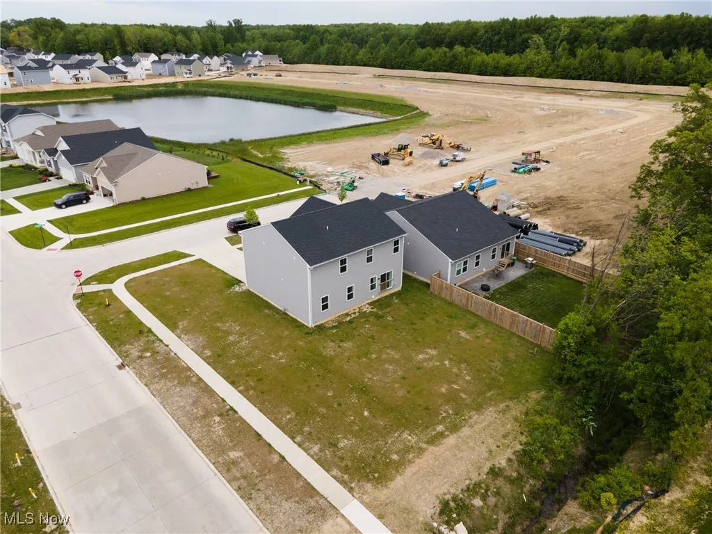 Aerial view of residential area featuring a nearby body of water