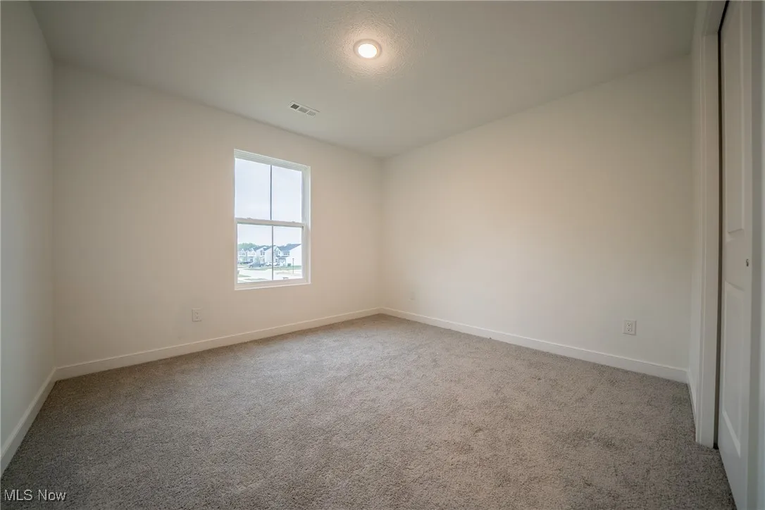 Unfurnished room featuring baseboards and carpet floors