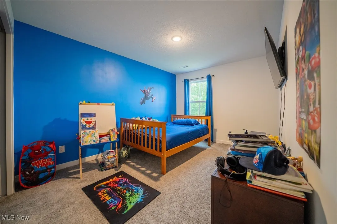 Carpeted bedroom with baseboards and recessed lighting
