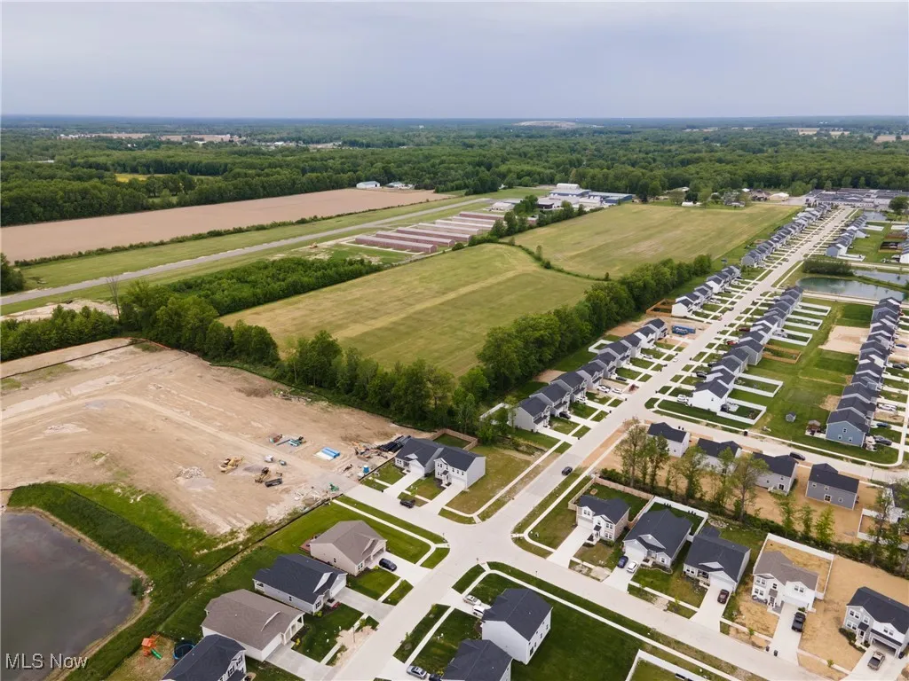 View of property location featuring a nearby body of water and nearby suburban area