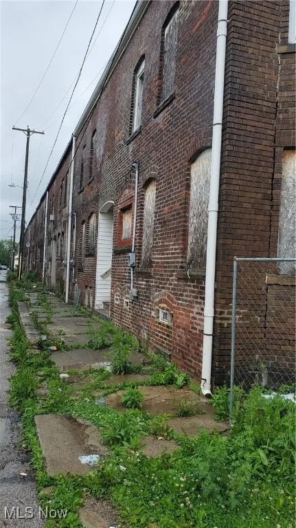 View of side of property featuring brick siding