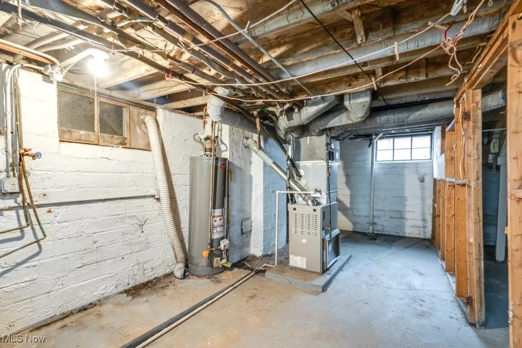 Below grade area featuring gas water heater and heating unit