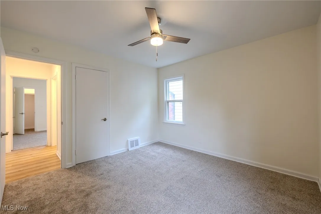 Unfurnished bedroom featuring carpet floors, baseboards, and ceiling fan