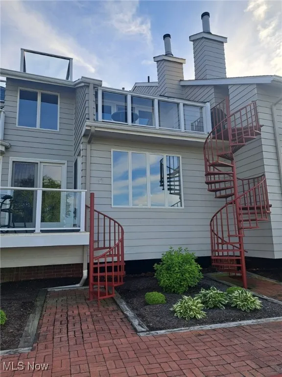 Back of house featuring stairs