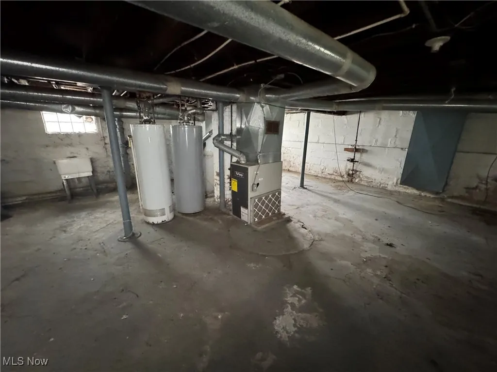 Below grade area featuring gas water heater and heating unit