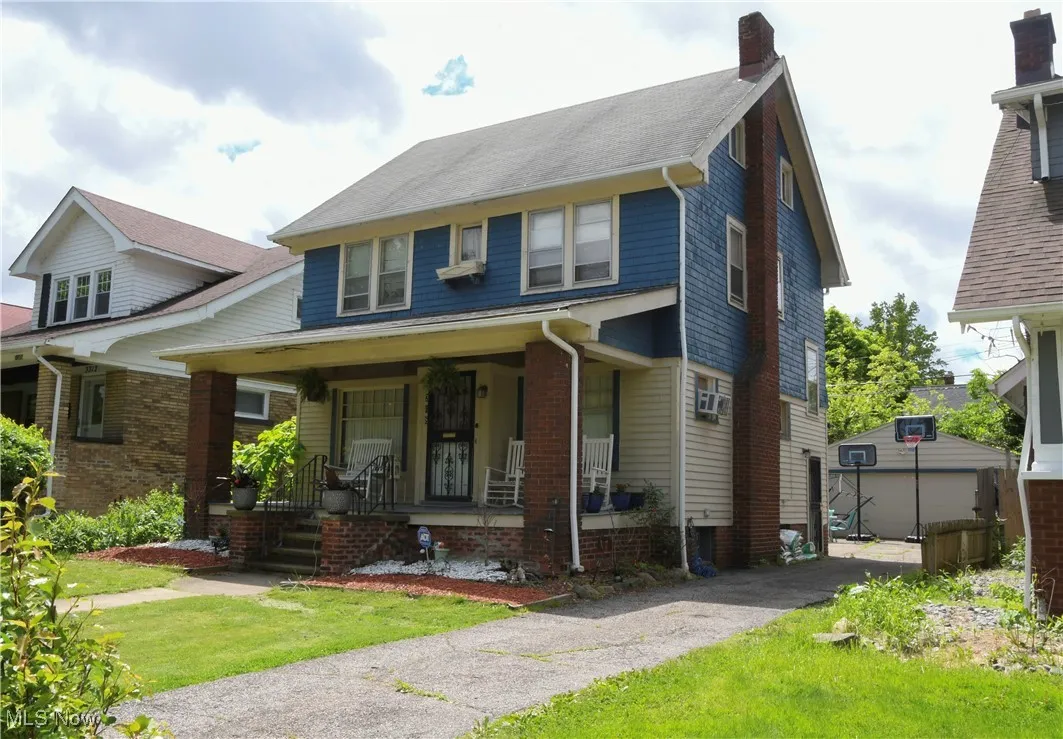 Traditional style home with a porch and a chimney