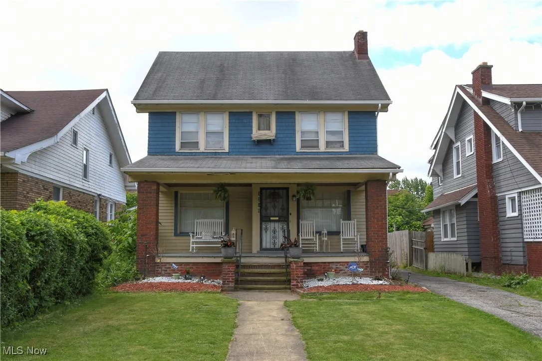 Traditional style home with a porch and a chimney