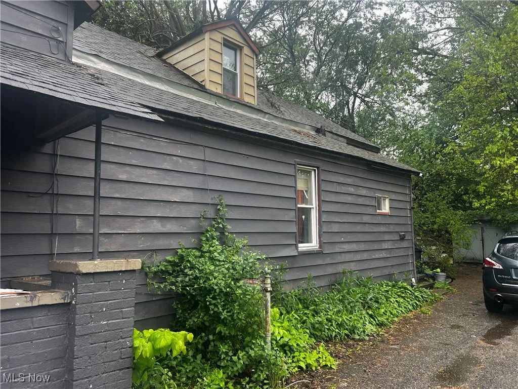 View of home's exterior with a shingled roof