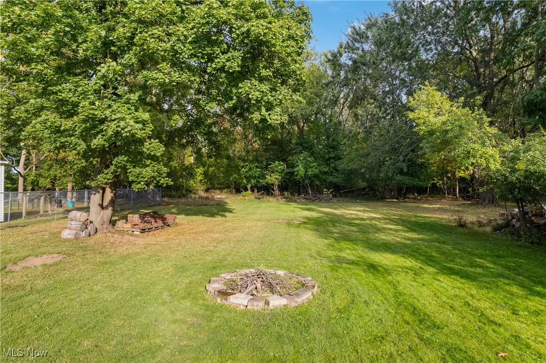 View of yard featuring an outdoor fire pit