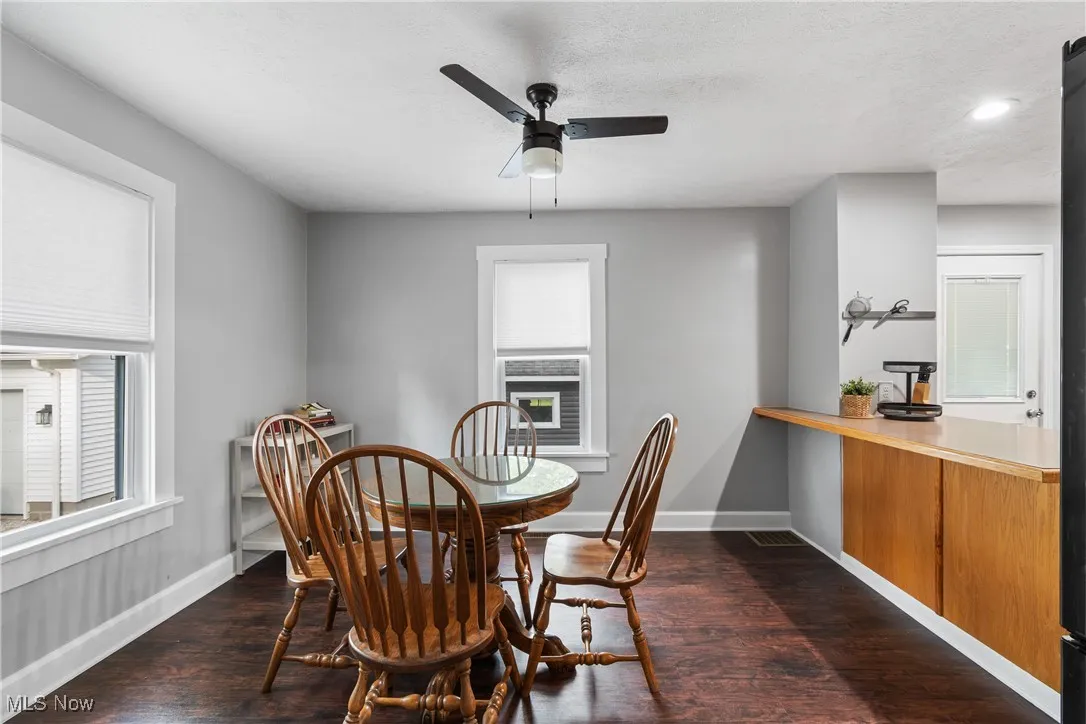 Dining room featuring plenty of natural light, baseboards, dark wood finished floors, and recessed lighting