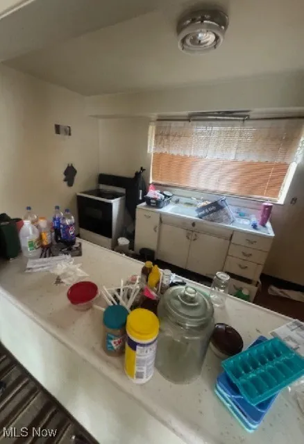 Kitchen featuring light countertops and electric range oven