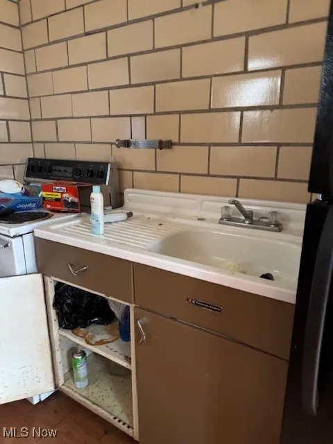 Interior details featuring a sink, light countertops, and stove