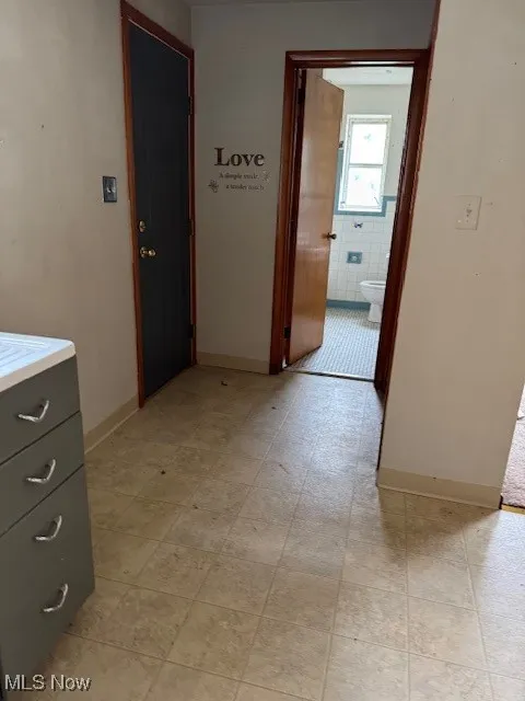 Hallway featuring baseboards