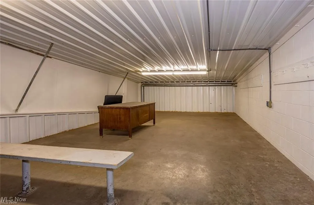 Basement featuring concrete block wall and a garage