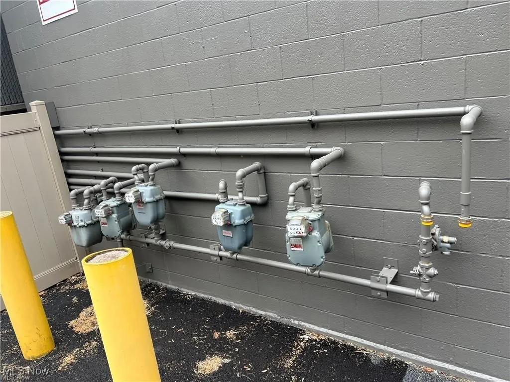 Exterior view of gas meter and concrete block siding