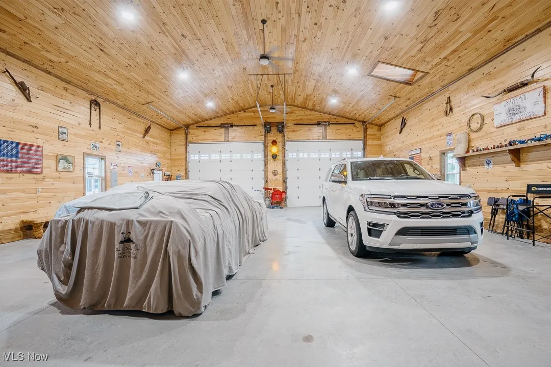 Garage with wood walls, recessed lighting, and wooden ceiling