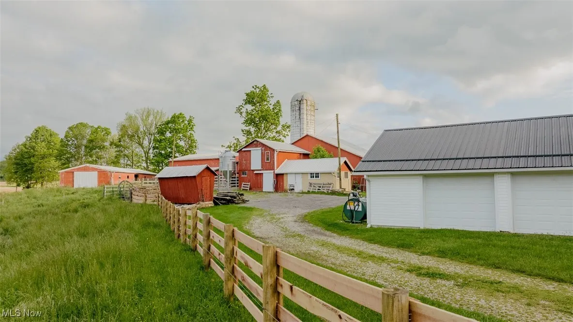 View of yard featuring driveway and a garage