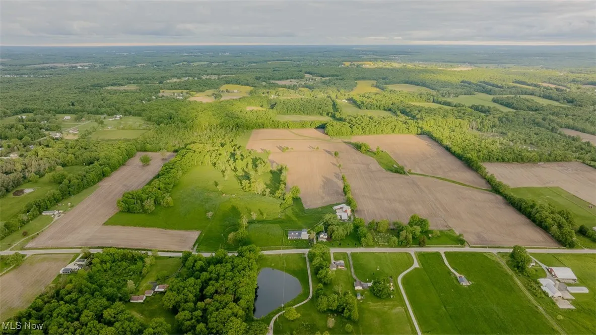 Aerial view of sparsely populated area featuring a nearby body of water
