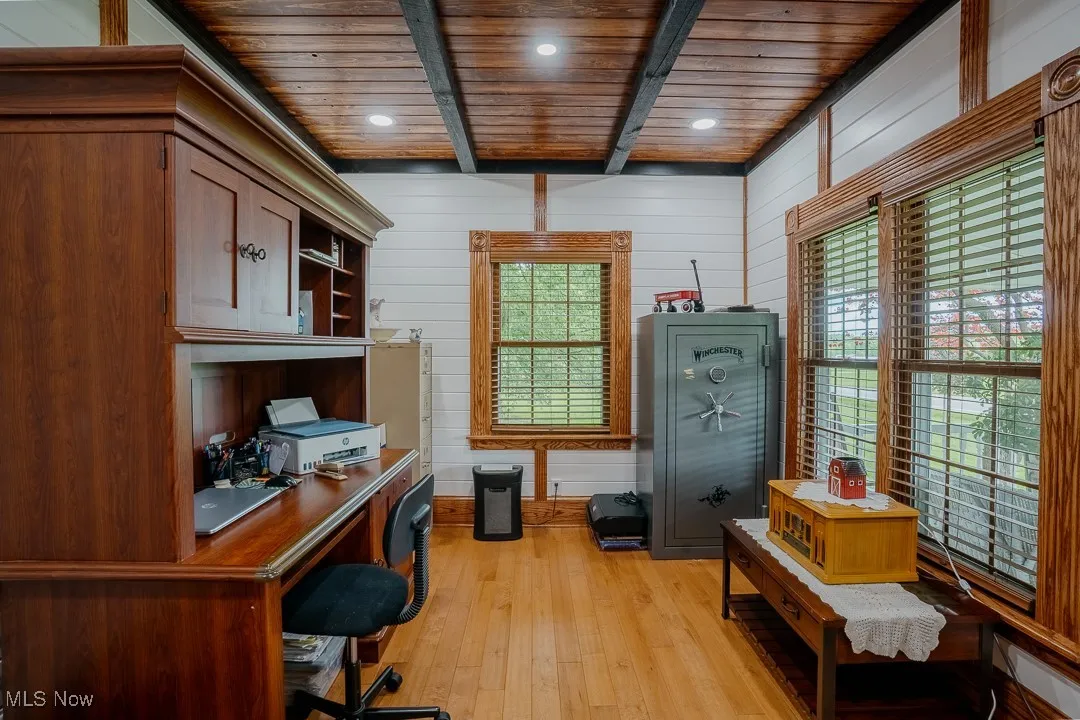 Office area featuring wood ceiling with exposed beams, light wood finished floors, plenty of natural light, recessed lighting, and wooden walls