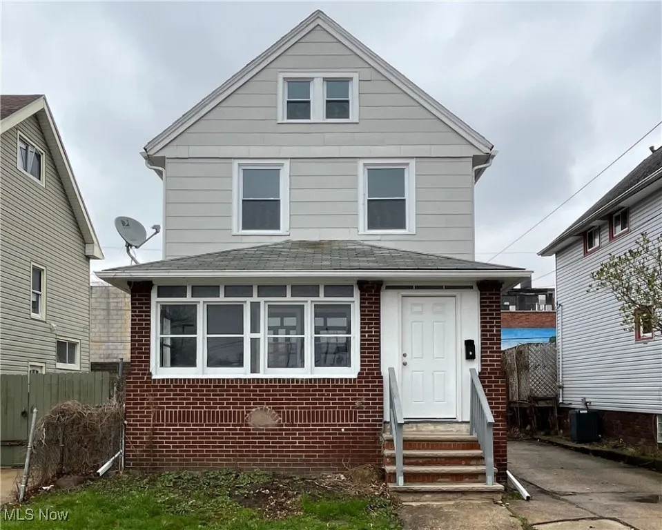 View of front of home featuring fence, a shingled roof, entry steps, cooling unit, and brick siding
