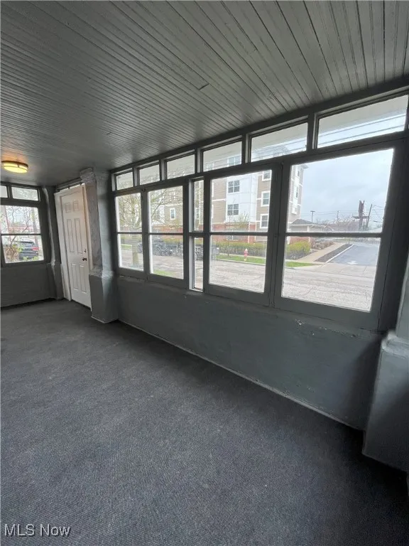 Unfurnished sunroom featuring plenty of natural light