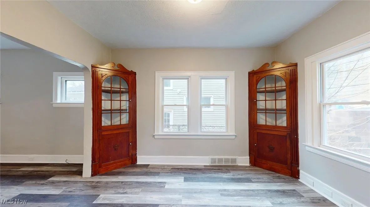 Doorway to outside with wood finished floors, visible vents, and a wealth of natural light