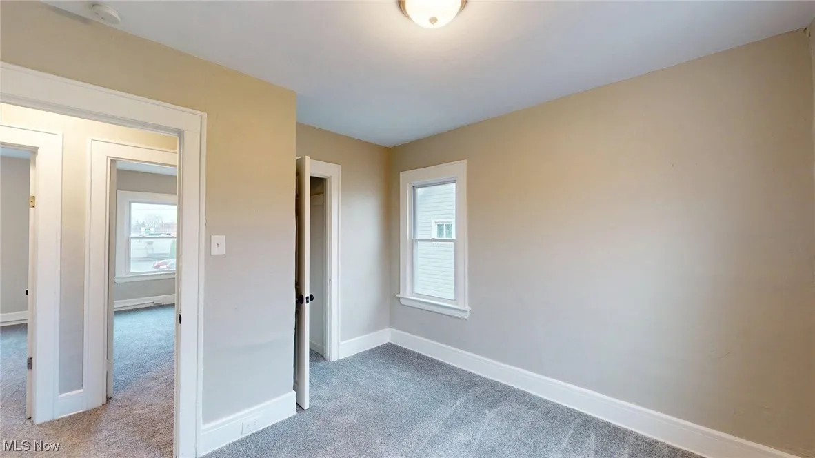 Unfurnished bedroom featuring carpet and baseboards