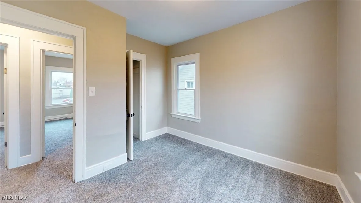 Unfurnished bedroom featuring carpet and baseboards
