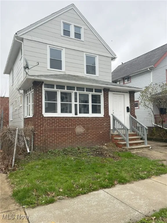 American foursquare style home with entry steps and brick siding