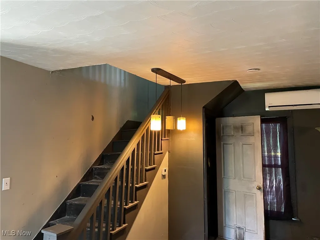 Stairs featuring a wall mounted air conditioner