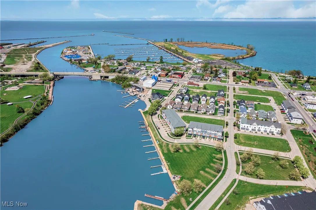 Aerial view of property and surrounding area featuring a large body of water