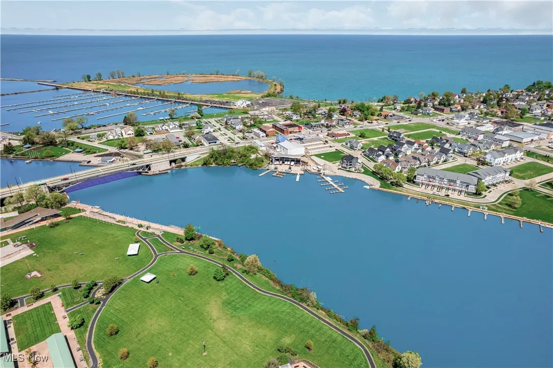 Aerial view of property and surrounding area featuring a large body of water