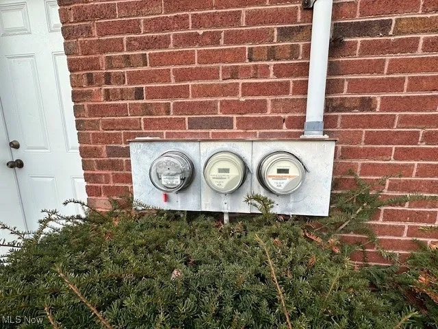 Exterior view of electric meter and brick siding