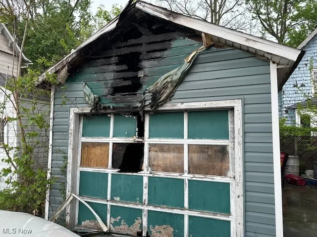 View of side of property featuring an outbuilding