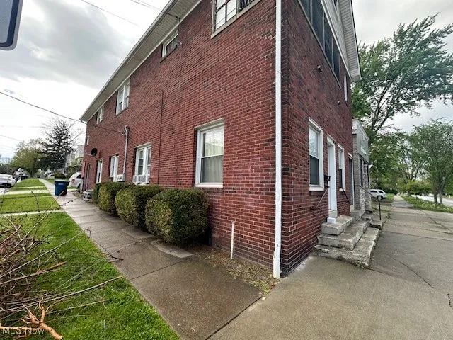 View of side of property with brick siding