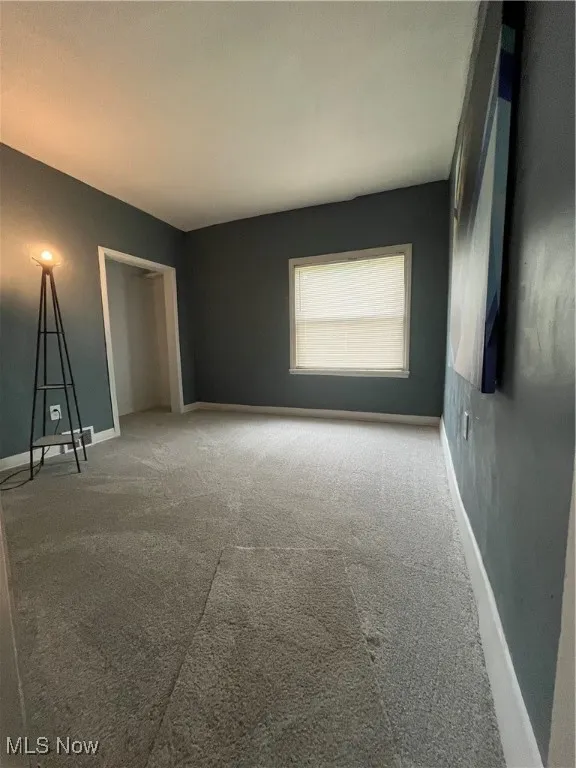 Unfurnished bedroom with carpet, baseboards, and a closet