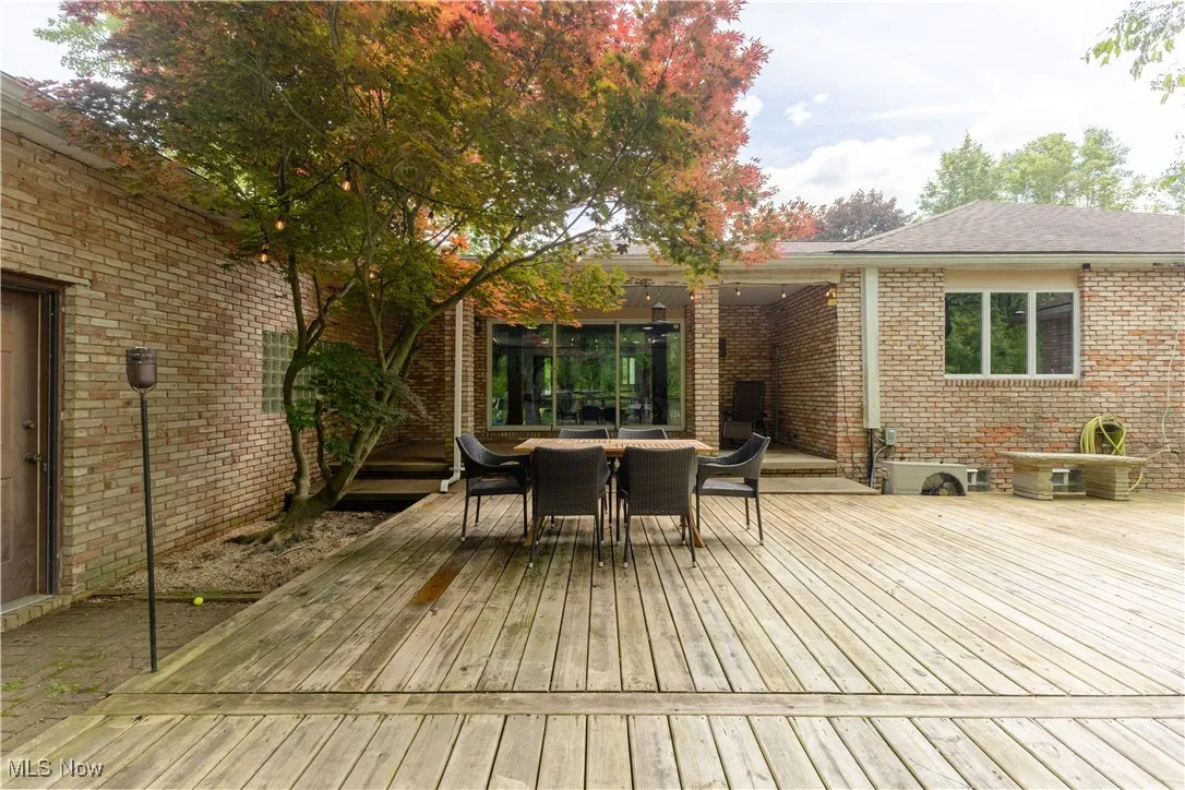 Wooden terrace featuring outdoor dining space