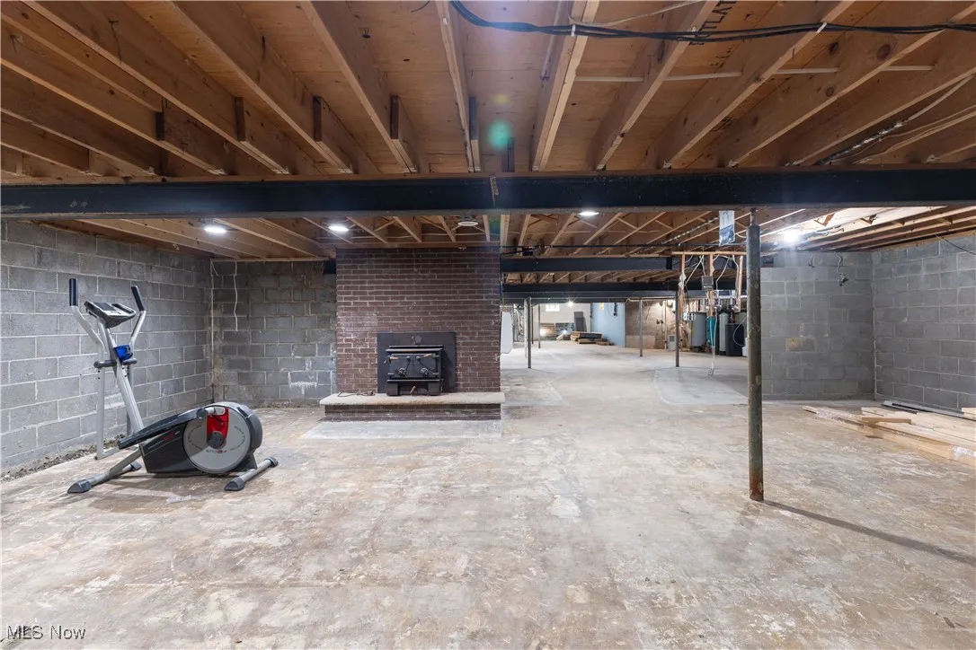 Unfinished basement featuring concrete block wall