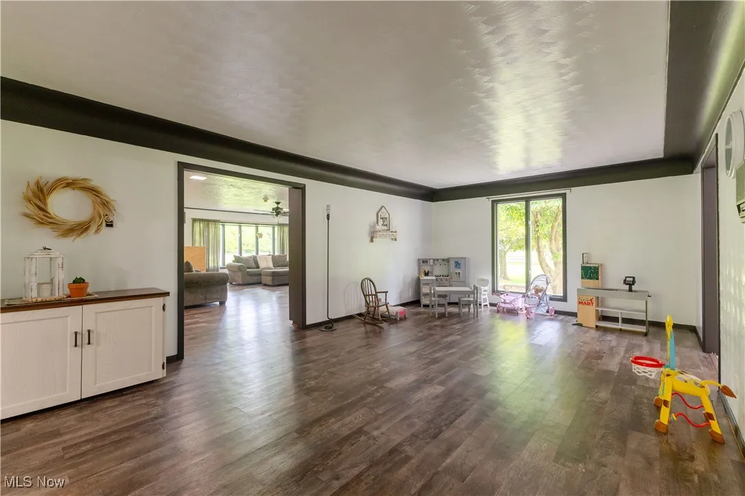 Living area featuring plenty of natural light and dark wood-style floors