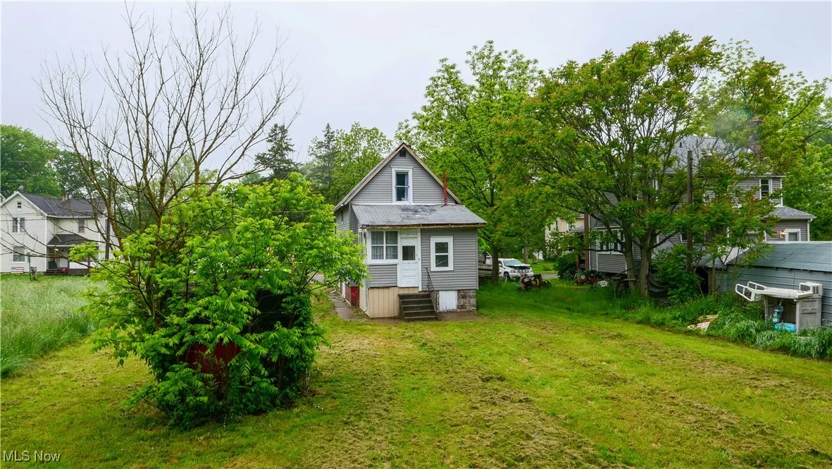 Rear view of house with a yard