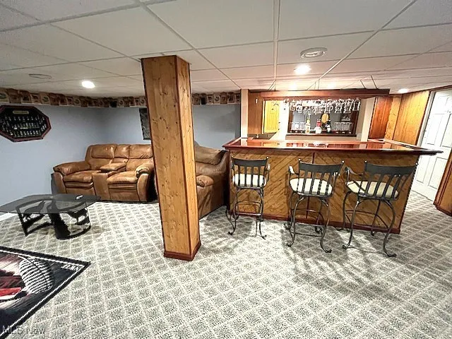 Indoor dry bar with carpet, a paneled ceiling, and recessed lighting
