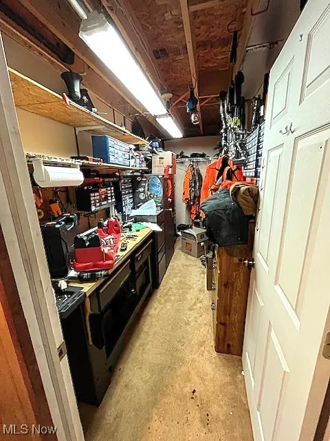 Walk in closet with a workshop area