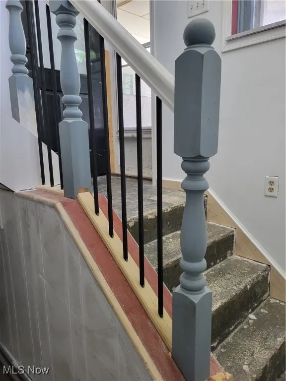 Stairway featuring wood finished floors and baseboards