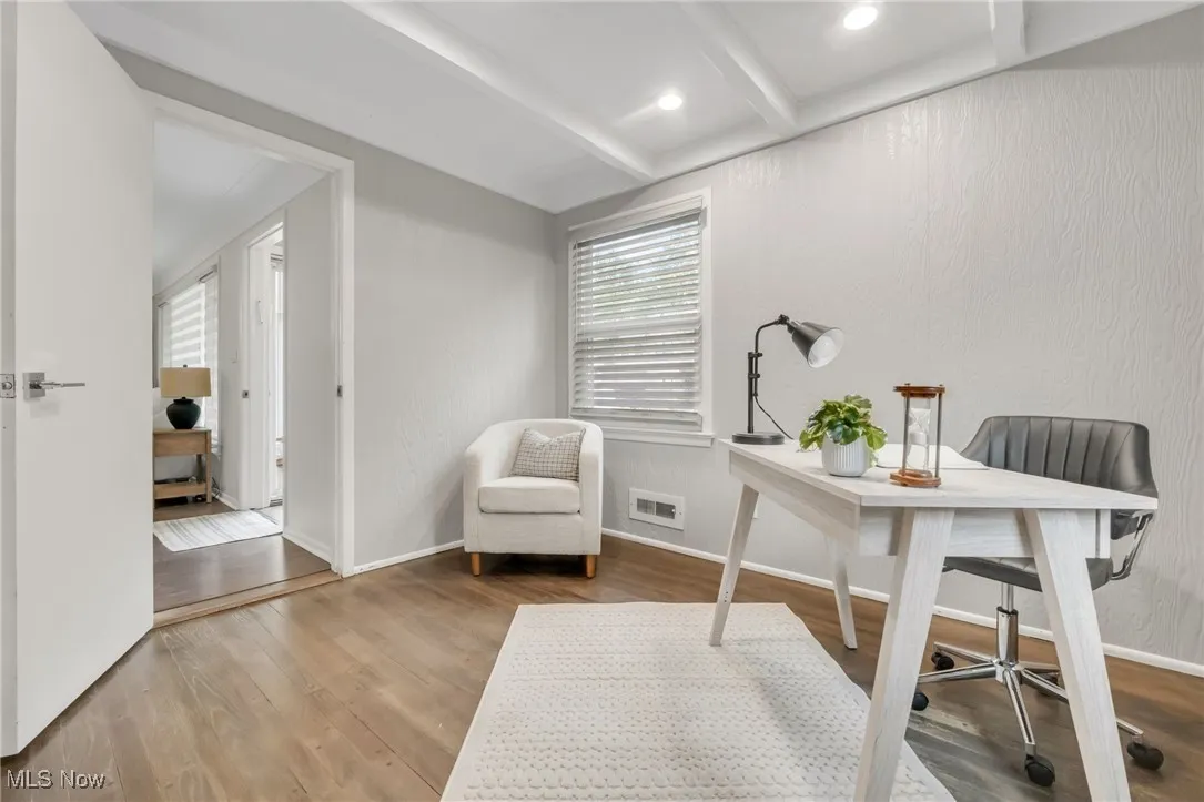 Office space with wood finished floors, beamed ceiling, recessed lighting, and baseboards
