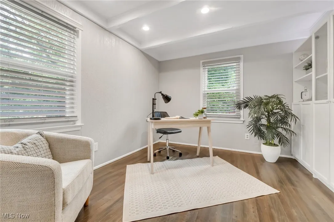 Home office with wood finished floors, beam ceiling, and baseboards