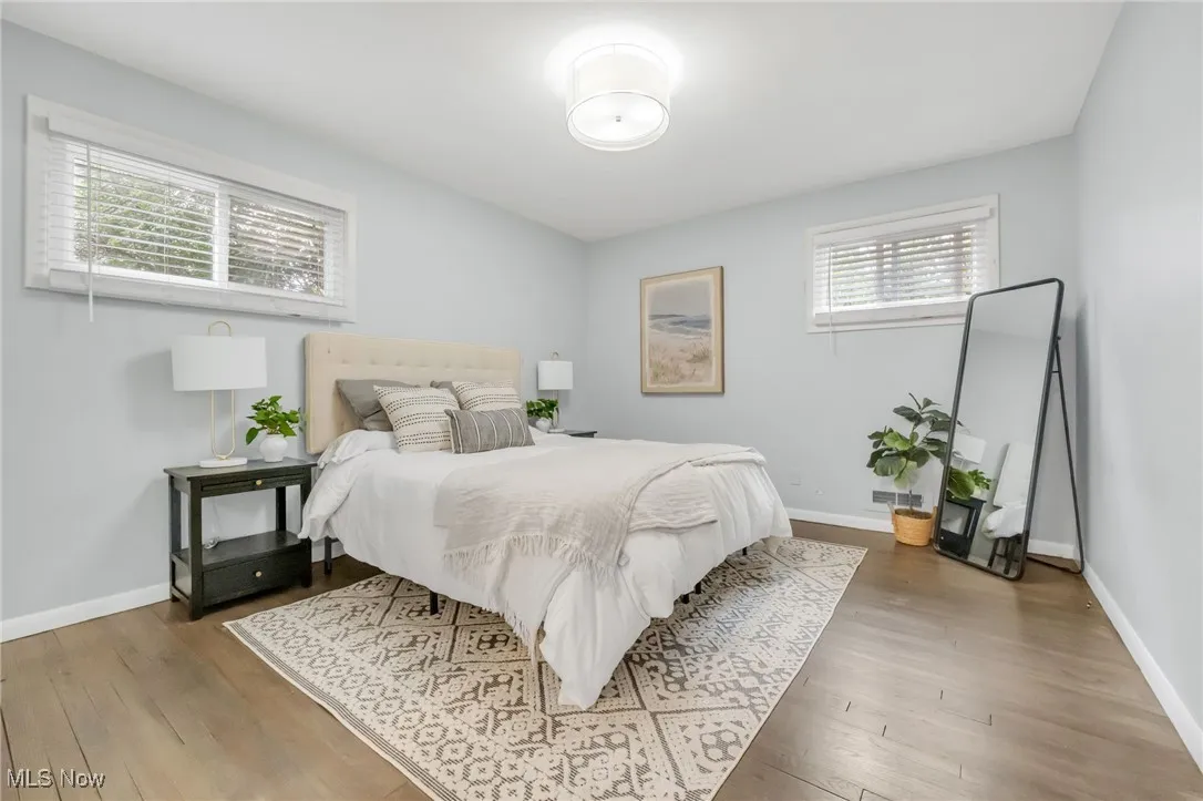 Bedroom with wood finished floors and baseboards