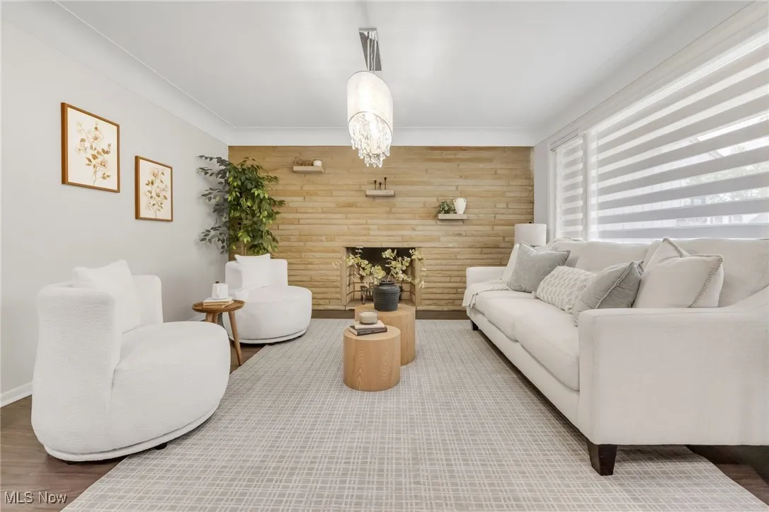 Living area featuring wooden walls, wood finished floors, and an accent wall