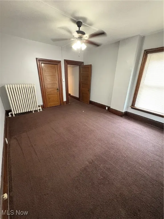 Unfurnished bedroom featuring carpet, baseboards, and ceiling fan